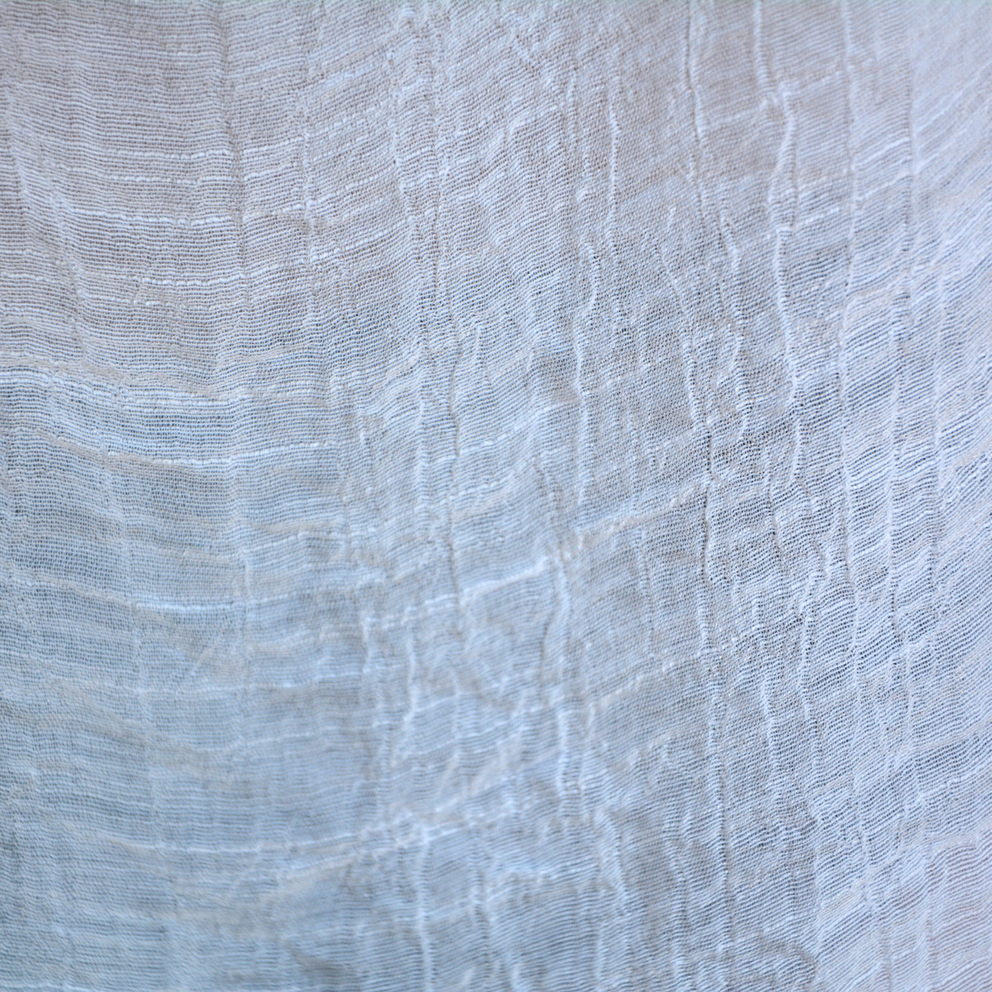 Close up of Bette moorea cover up material in white