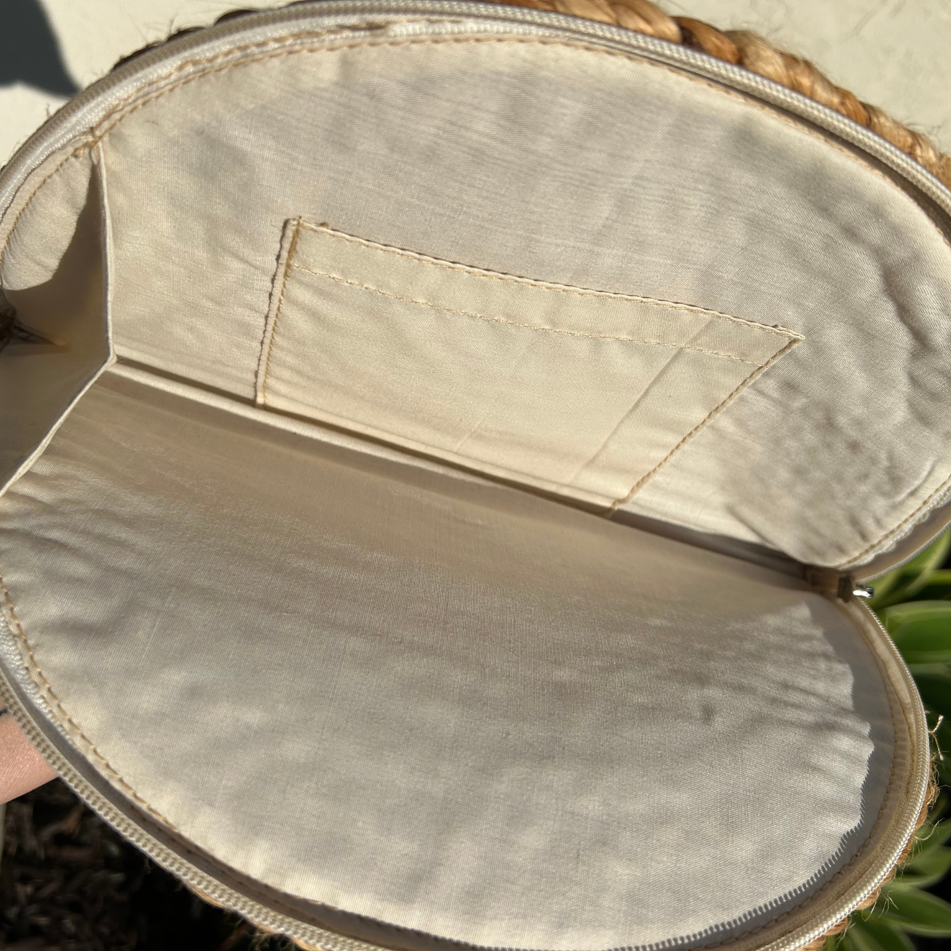 Braided jute clutch with zipper closure and cotton lining