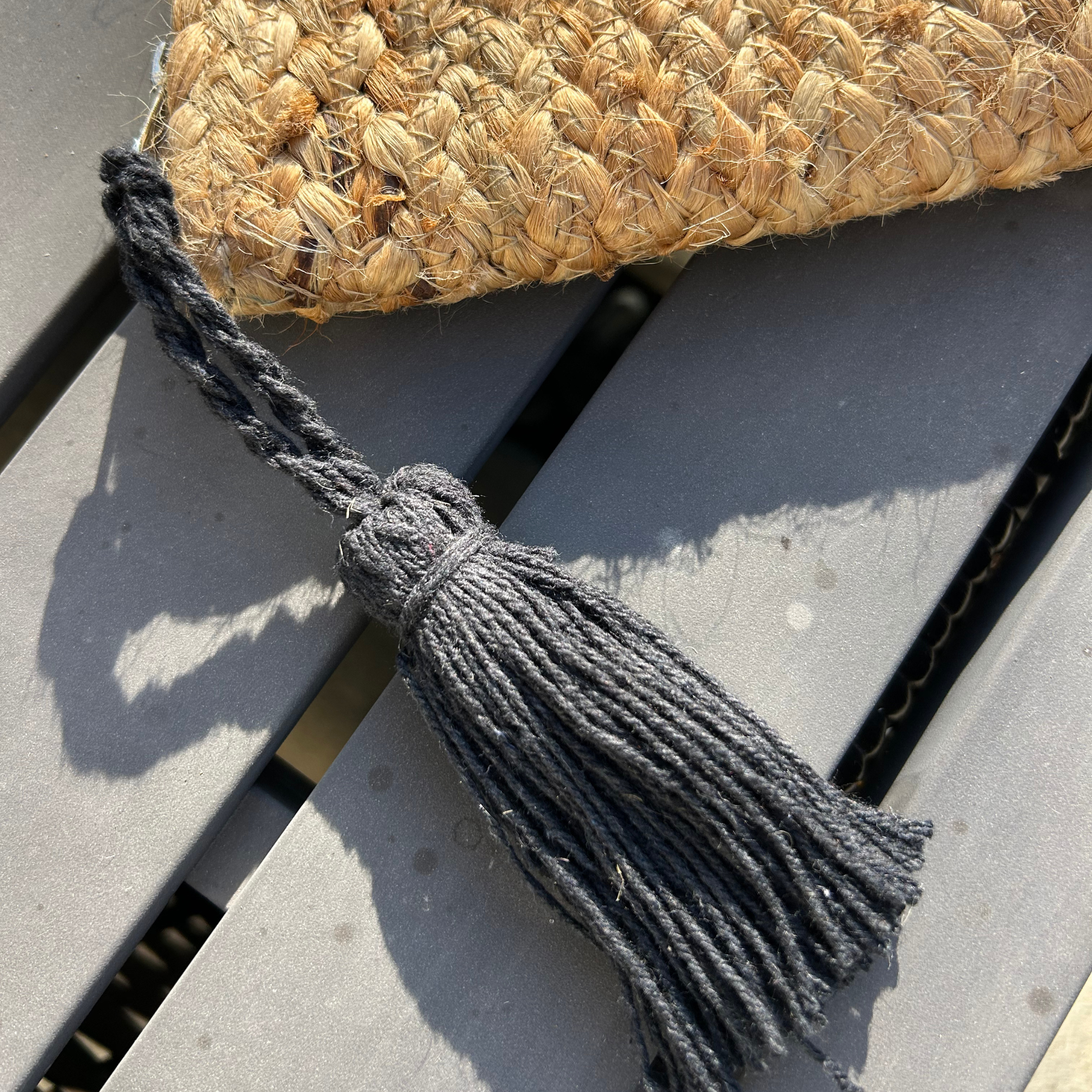 Artisan handcrafted jute clutch bag with tassel detail