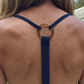 Navy blue halter top with a tortoise shell ring design on a person's back.