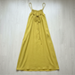 Yellow maxi dress on a wooden floor