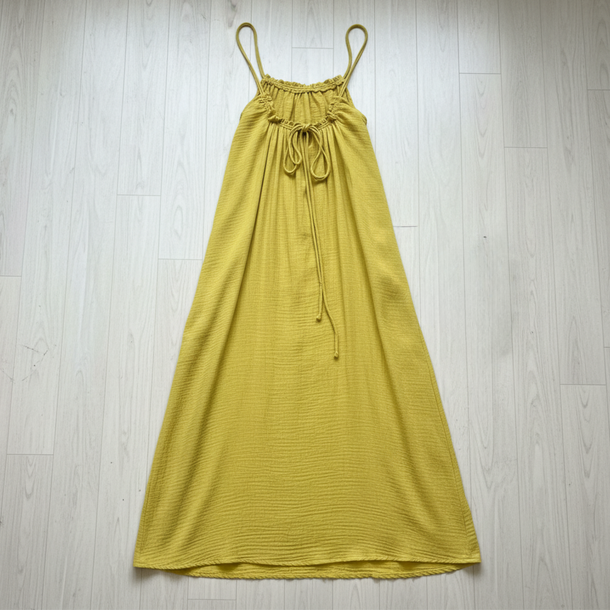 Yellow maxi dress on a wooden floor
