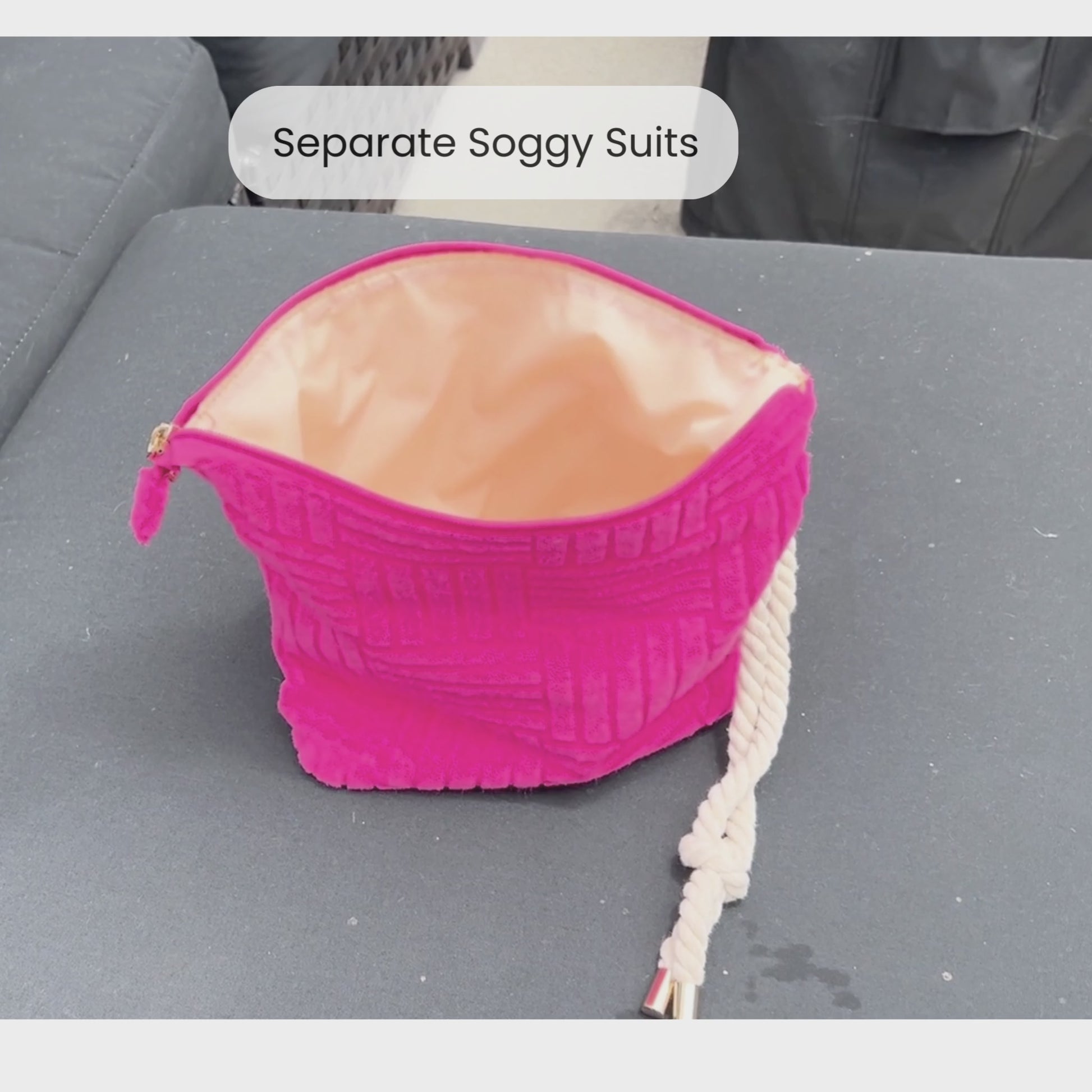 Video of someone putting a wet swimsuit into a pink waterproof bag that is terry cloth on the outside with a rope tassel