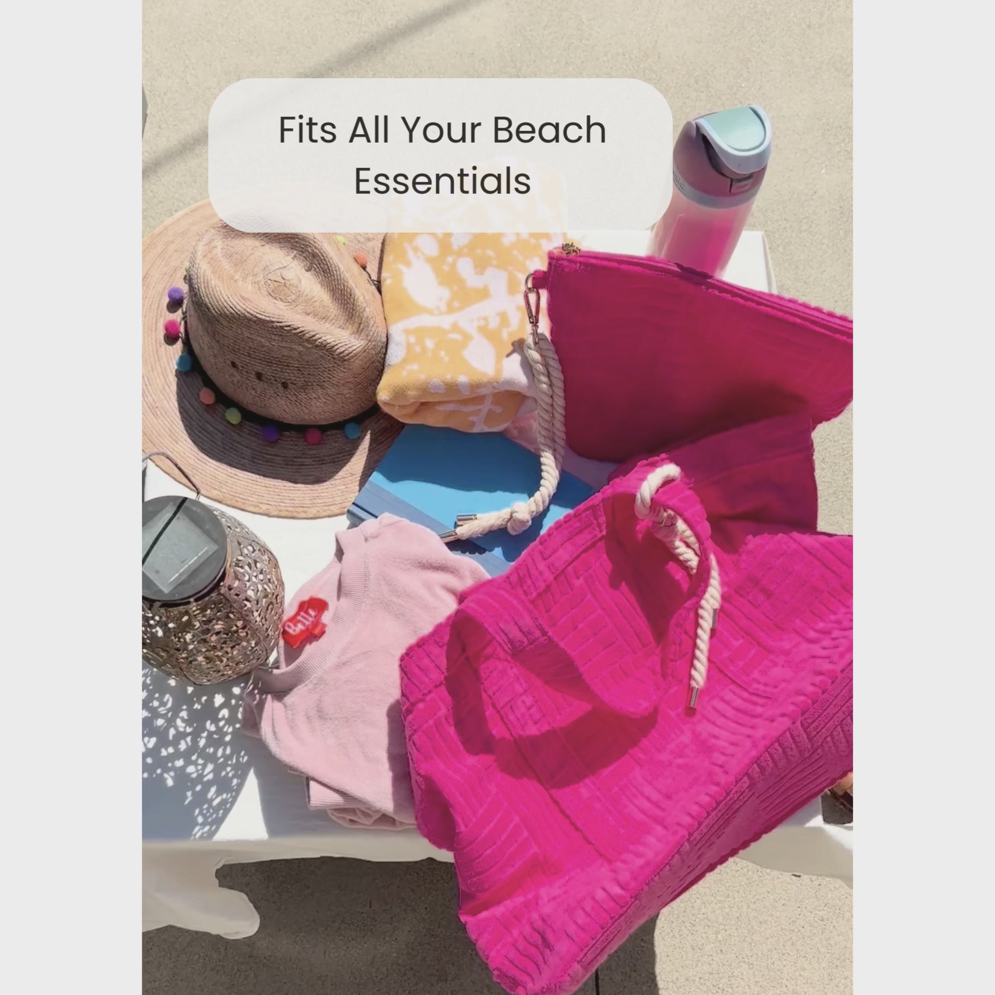 Video of someone packing a pink terry cloth tote for the beach