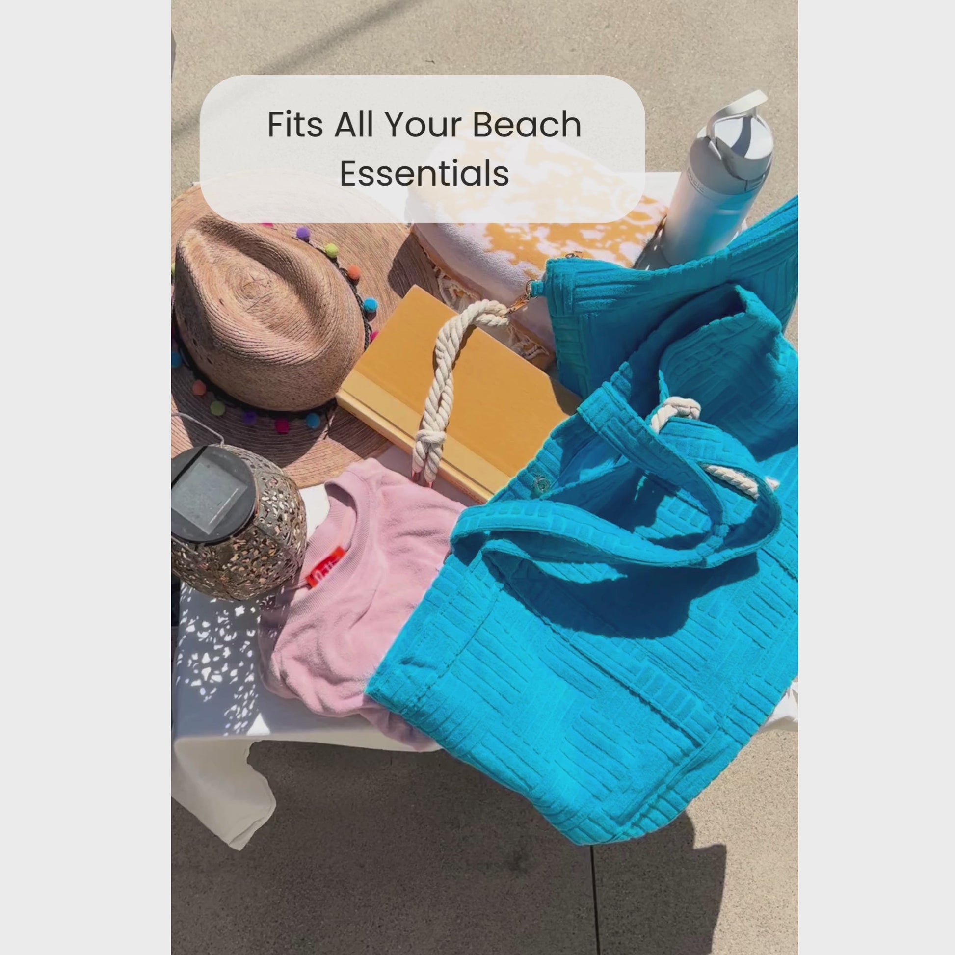 Video of someone packing a blue terry cloth tote for the beach