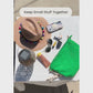 Video of someone packing small essentials into a green terry cloth pouch with rope tassel